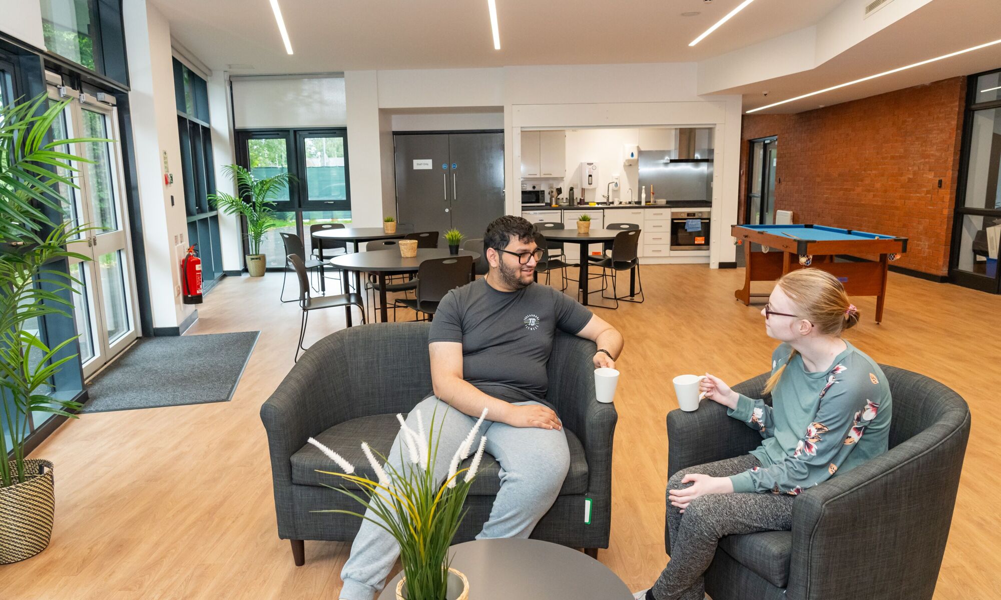 Pioneer house high school - 2 students chatting in canteen
